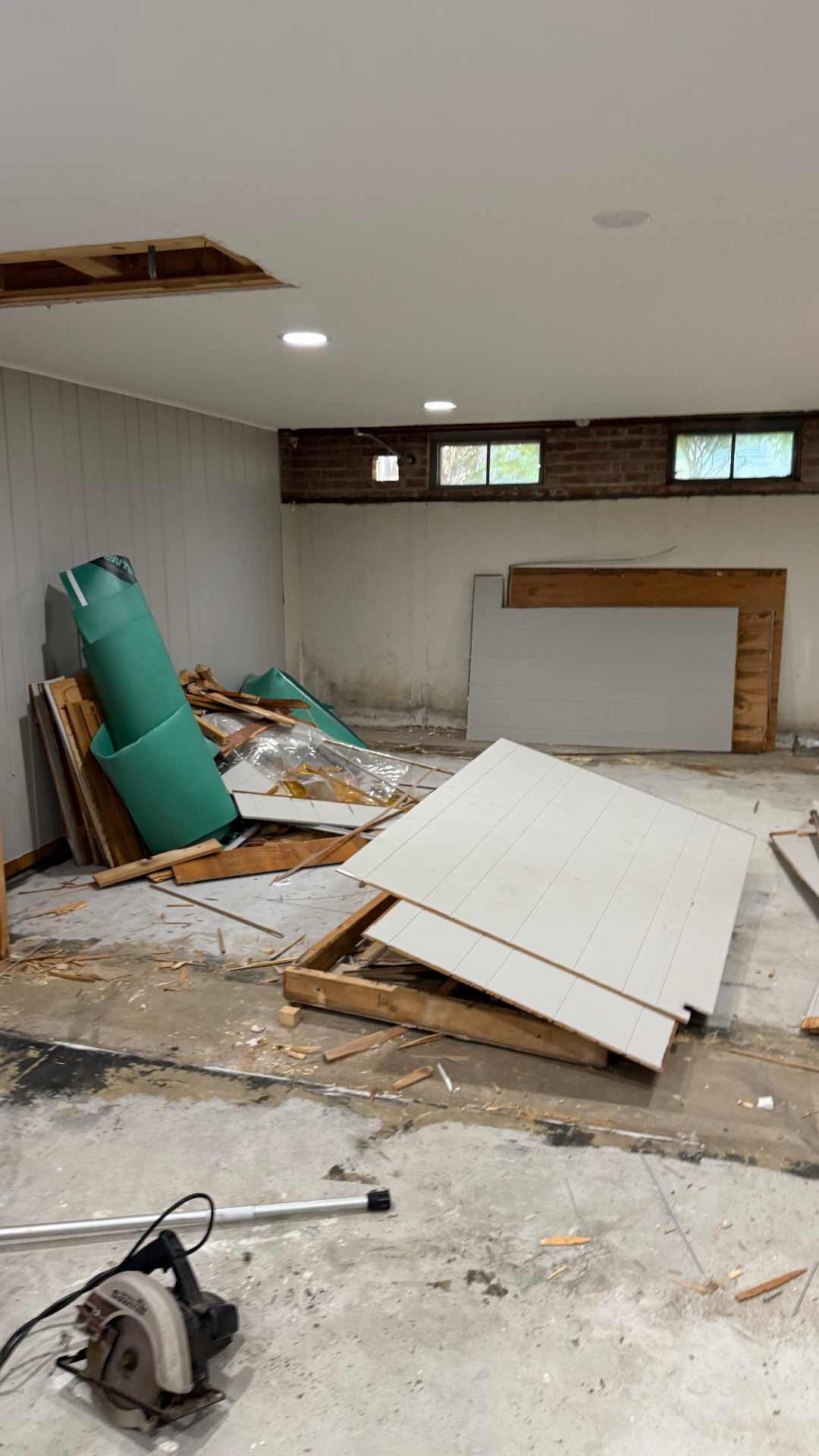 Basement clearout Arlington Heights IL — debris and old wall panels removed during interior cleanout