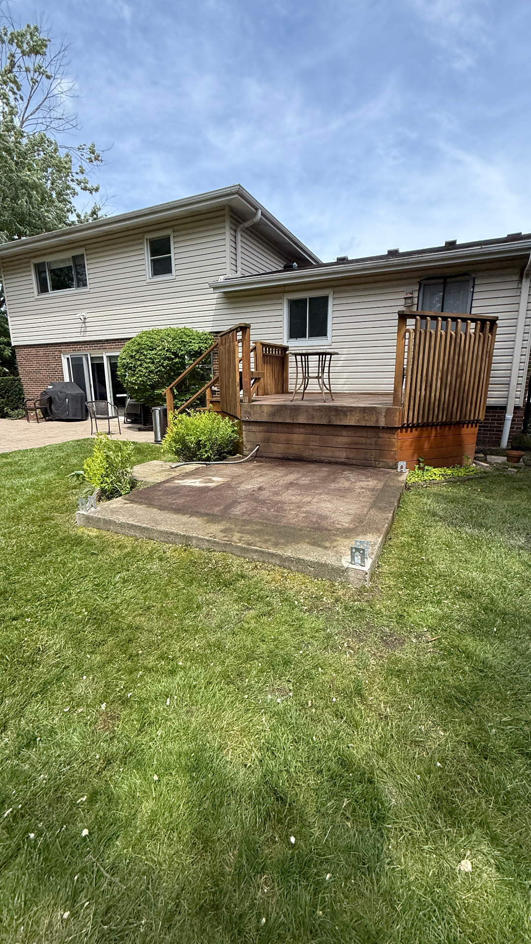 Hot tub removal Deerfield Illinois — backyard cleared after jacuzzi demo with concrete pad exposed