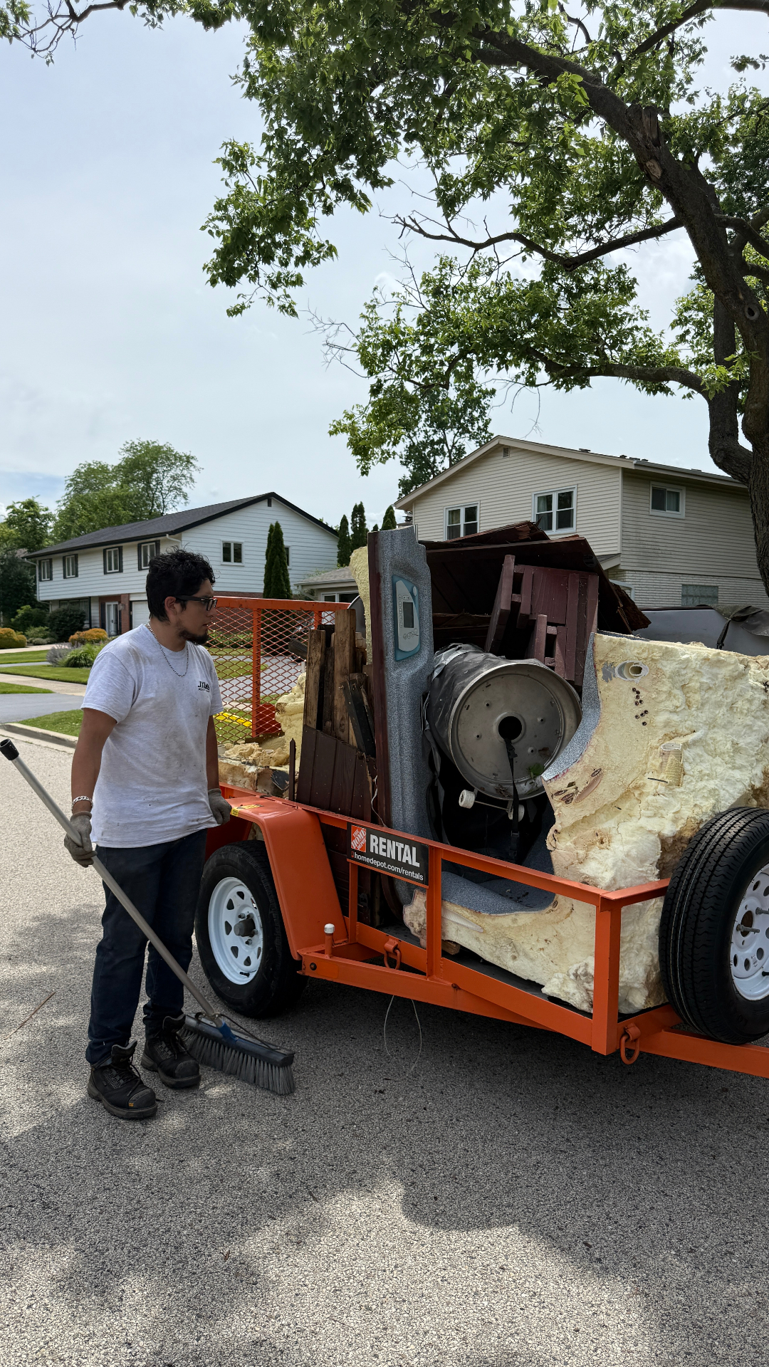 Jacuzzi haul away Deerfield IL — JXL crew loading hot tub debris, foam and shell pieces onto trailer