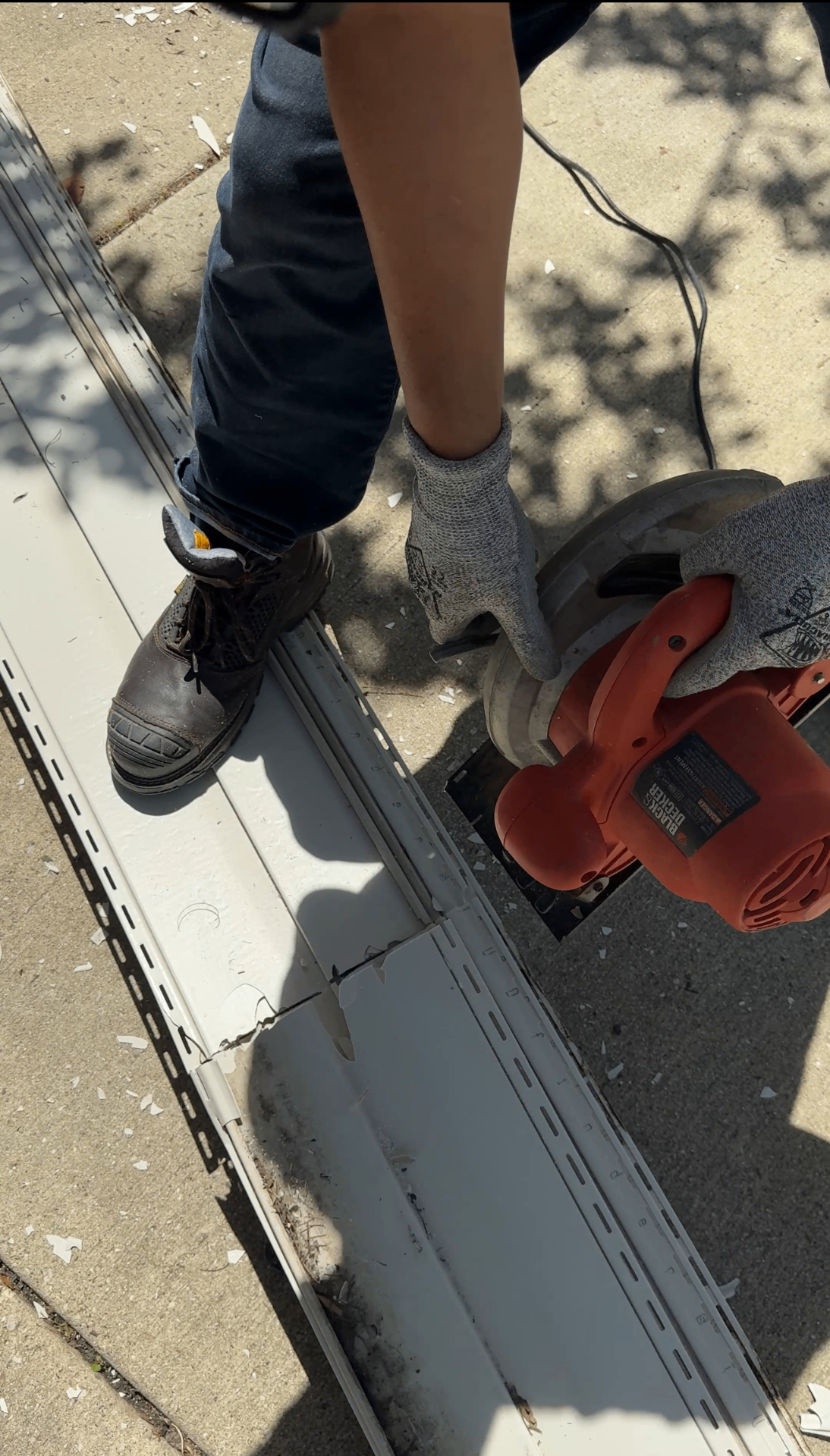 Siding removal Hanover Park IL — cutting vinyl siding on jobsite