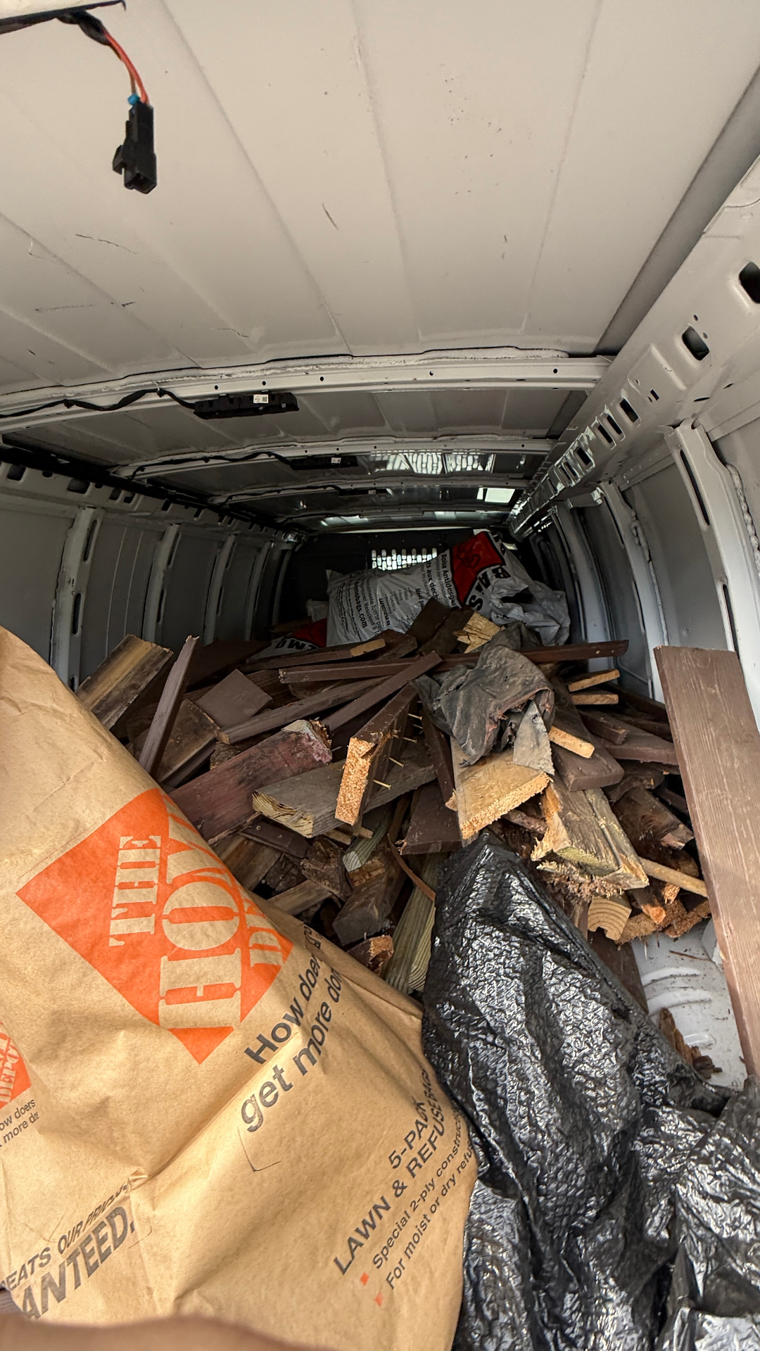 Patio debris haul away Streamwood IL — van loaded with old patio wood and demo bags for disposal