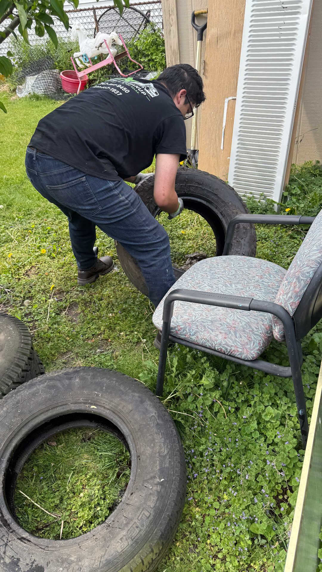 Garage side cleanup Wheeling Illinois — rotted wood and debris pile